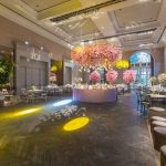 Elegant wedding reception in a luxurious hall with stunning flower arrangements and ambient lighting. — Winter Roof Collapses