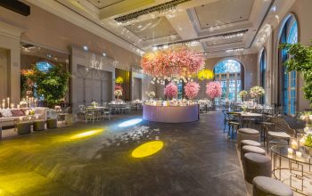 Elegant wedding reception in a luxurious hall with stunning flower arrangements and ambient lighting. — Winter Roof Collapses