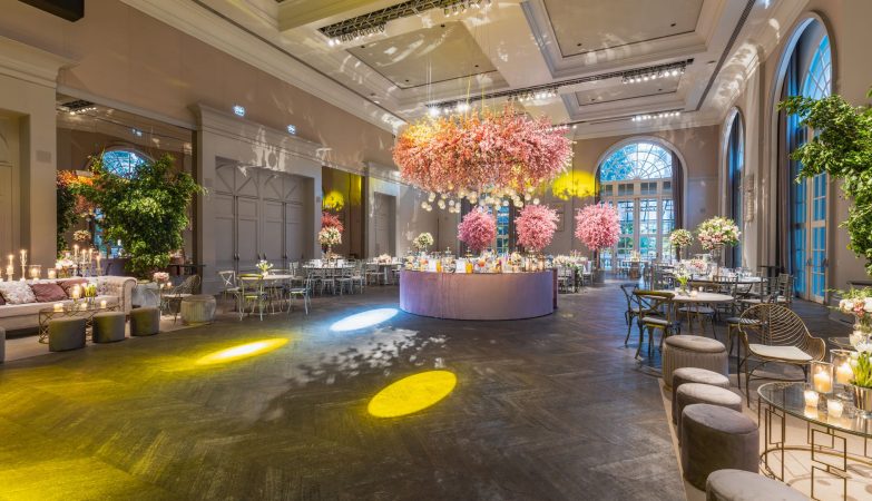 Elegant wedding reception in a luxurious hall with stunning flower arrangements and ambient lighting. — Winter Roof Collapses